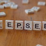 A wooden table topped with scrabble tiles spelling the word depeseek